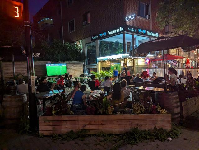 people watching soccer on bar terrace