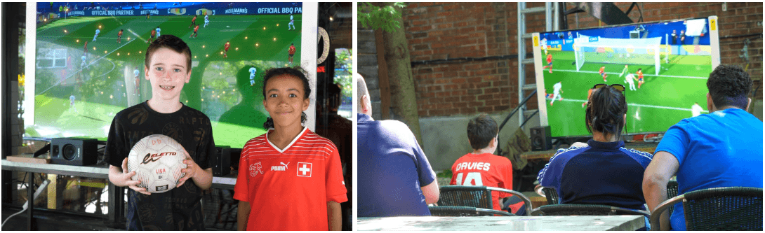 kids with soccer ball and people watching soccer